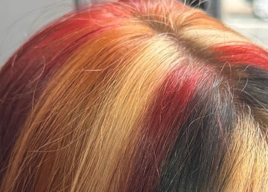 Colorful hair highlights at Aaran Sutton Hair, Aberdeen, Scotland, GB, showcasing vibrant hues and expert styling.