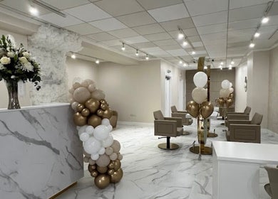 Chic and inviting interior of Aaran Sutton Hair in Aberdeen, Scotland, GB, adorned with elegant decor and balloons.
