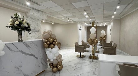 Chic and inviting interior of Aaran Sutton Hair in Aberdeen, Scotland, GB, adorned with elegant decor and balloons.