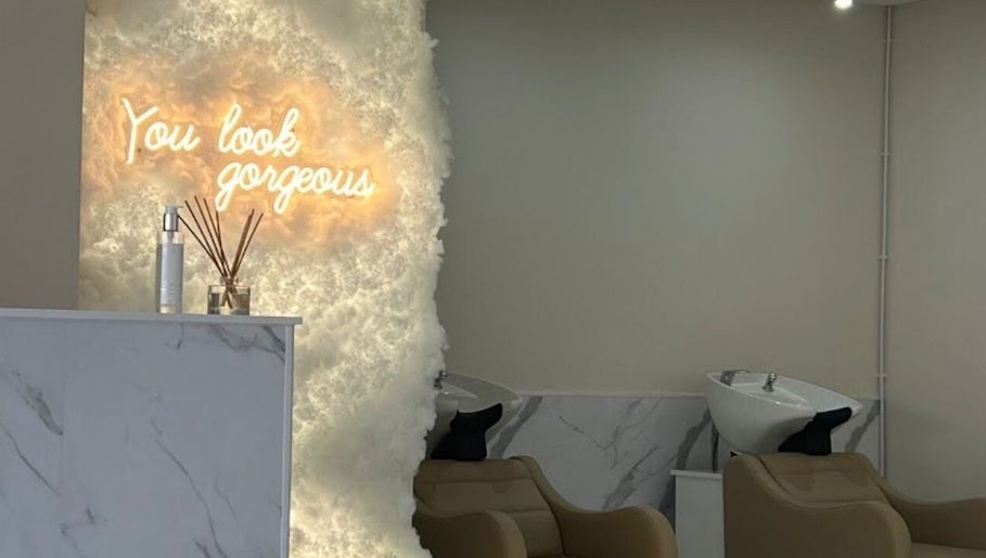 Chic hair salon interior with 'You Look Gorgeous' neon at Aaran Sutton Hair, Aberdeen, Scotland, GB.