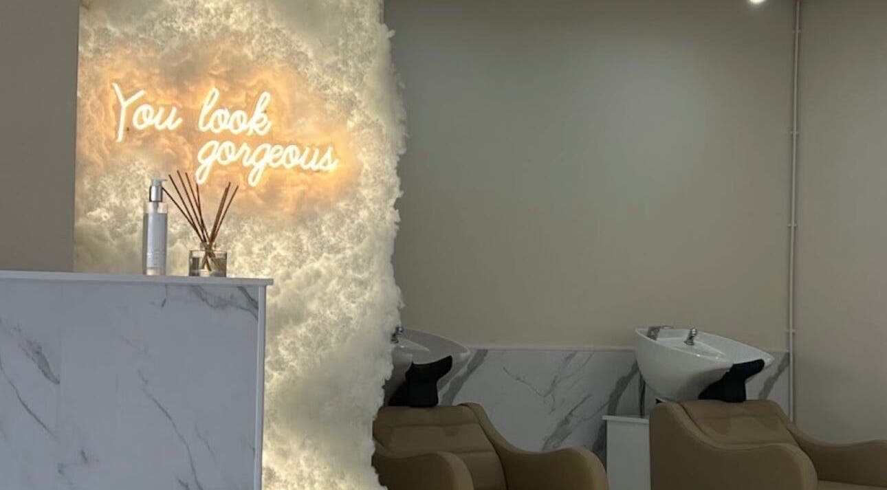Chic hair salon interior with 'You Look Gorgeous' neon at Aaran Sutton Hair, Aberdeen, Scotland, GB.