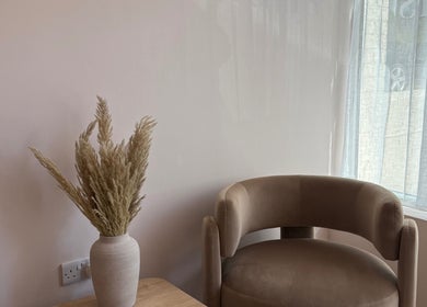 Inviting seating area at Lauren Willett Bespoke Hair the Loft, Bexhill, England, GB. Cozy chair and vase.