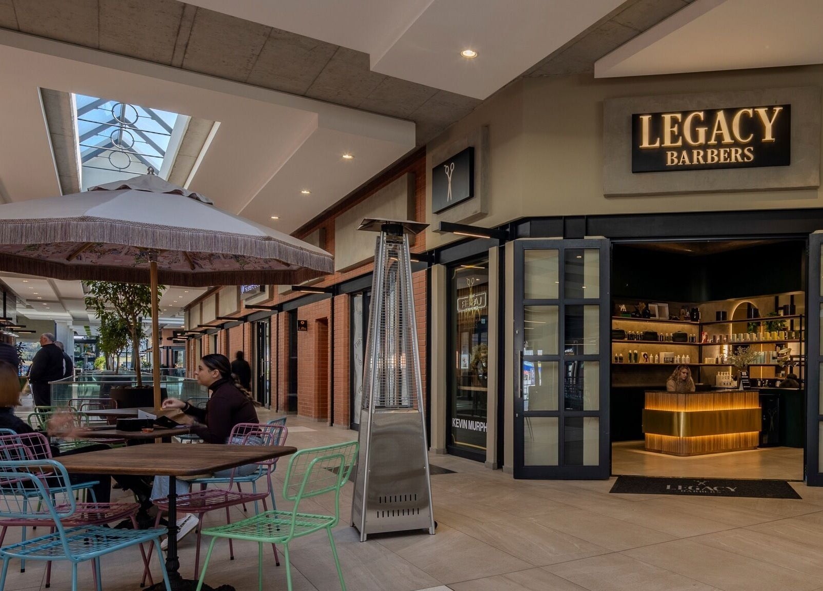 Legacy Barbers - The Verge in Johannesburg, Gauteng, ZA, showcases a stylish entrance with outdoor seating.