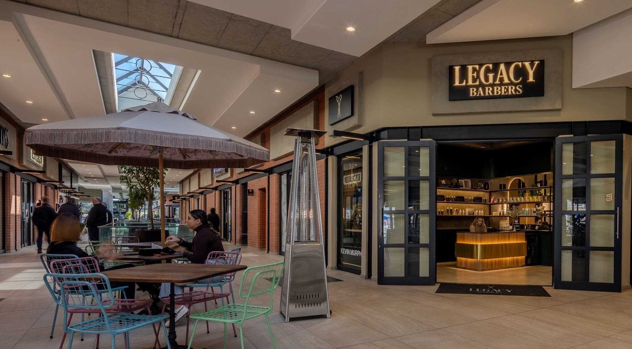 Legacy Barbers - The Verge in Johannesburg, Gauteng, ZA, showcases a stylish entrance with outdoor seating.