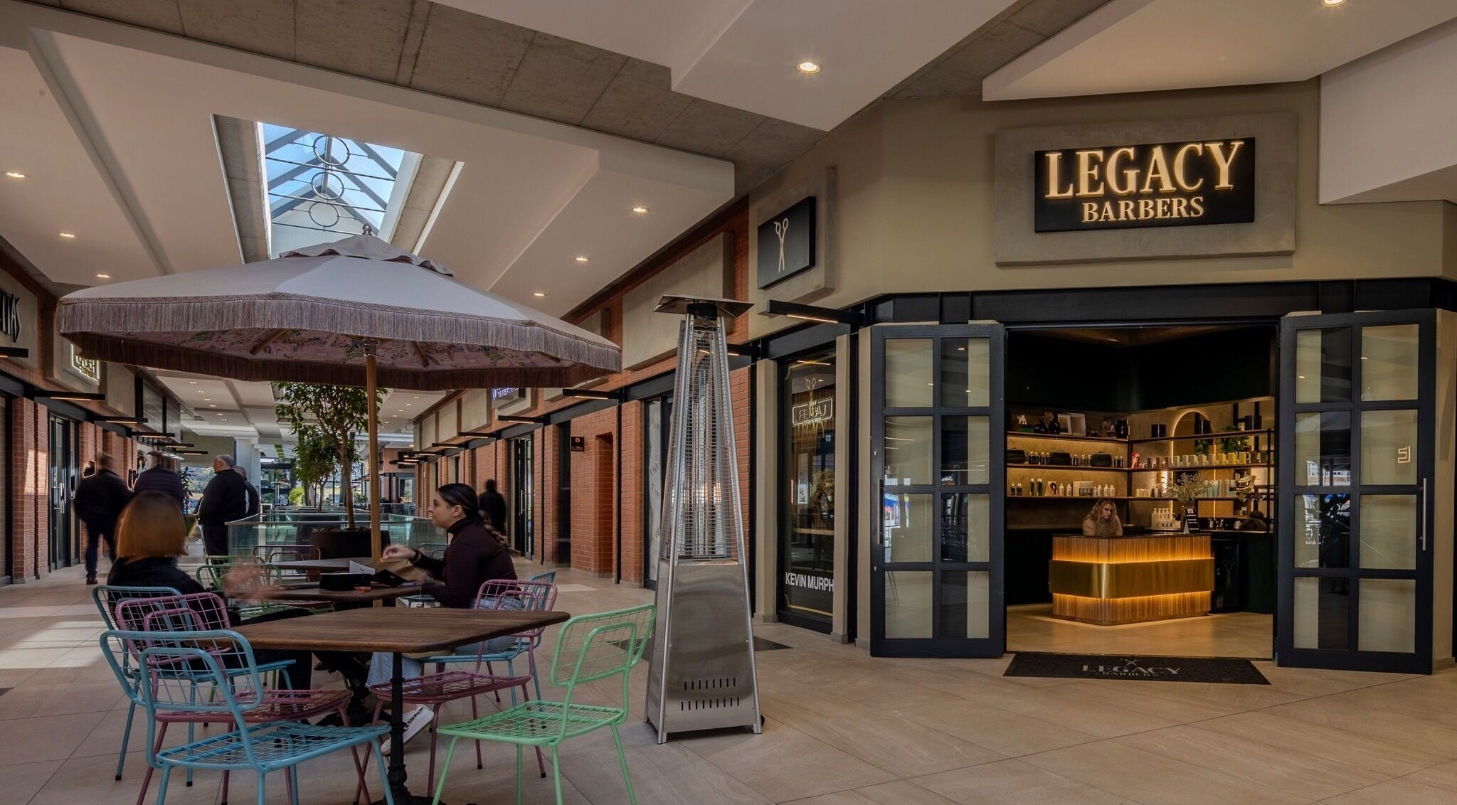 Legacy Barbers - The Verge in Johannesburg, Gauteng, ZA, showcases a stylish entrance with outdoor seating.