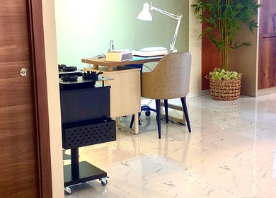 Elegant nail workspace at Nail Boutique By Leann, Il-gżira, MT, featuring stylish furniture and greenery.