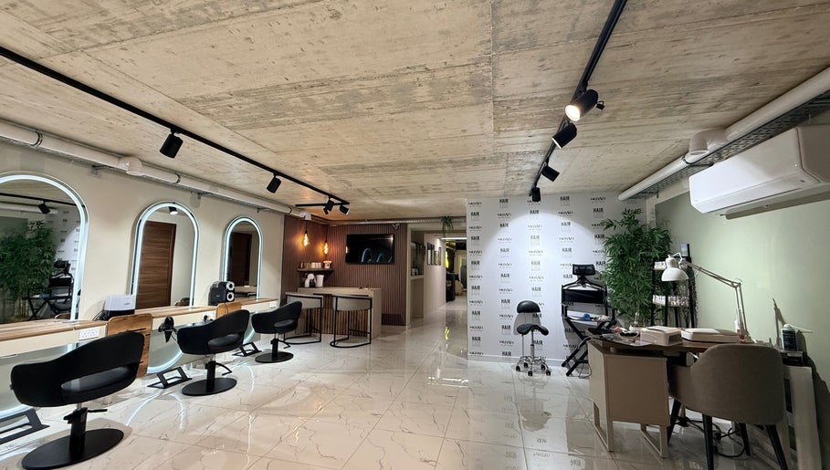 Modern salon interior of Nail Boutique By Leann in Il-gżira, MT with stylish seating and mirrors.