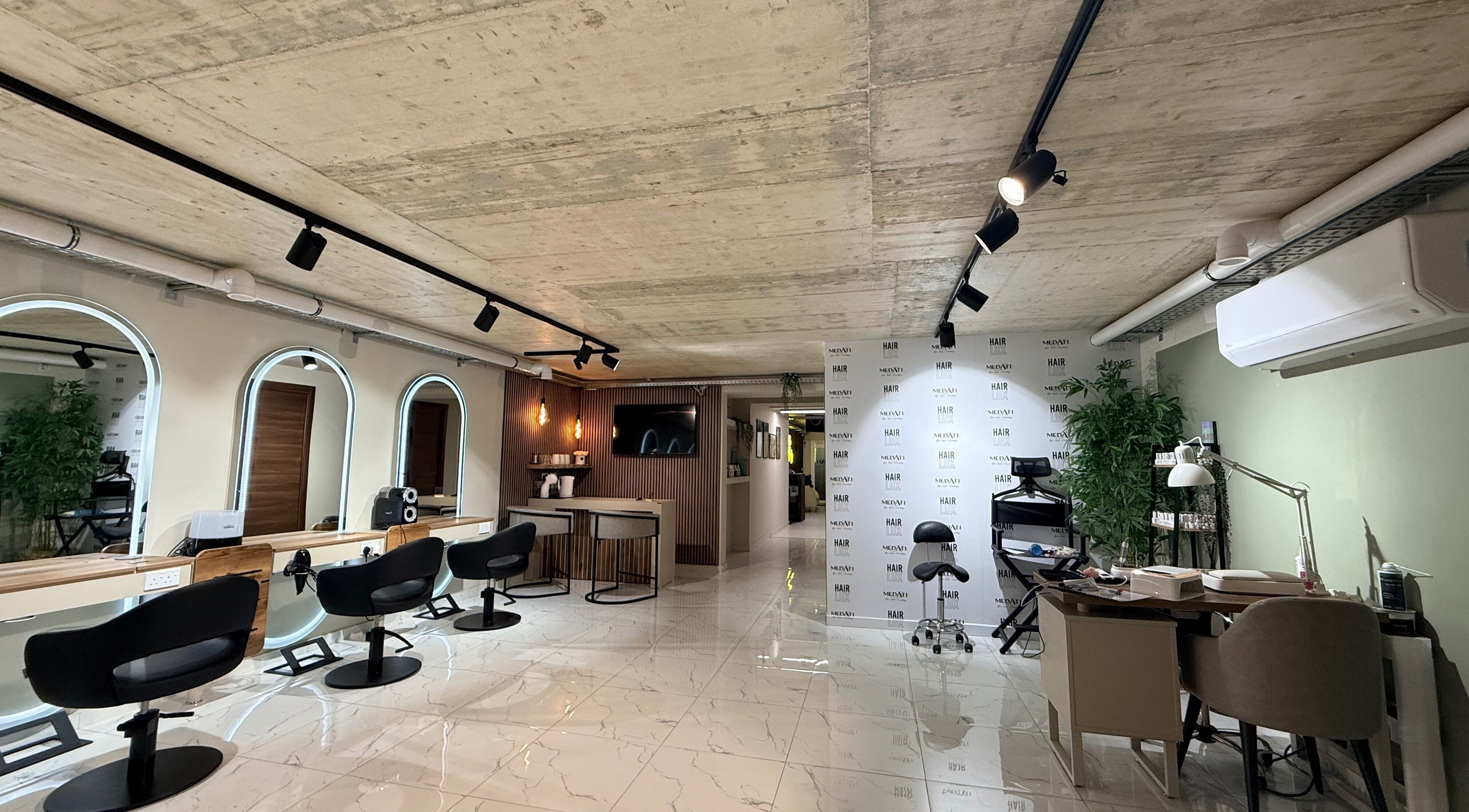 Modern salon interior of Nail Boutique By Leann in Il-gżira, MT with stylish seating and mirrors.