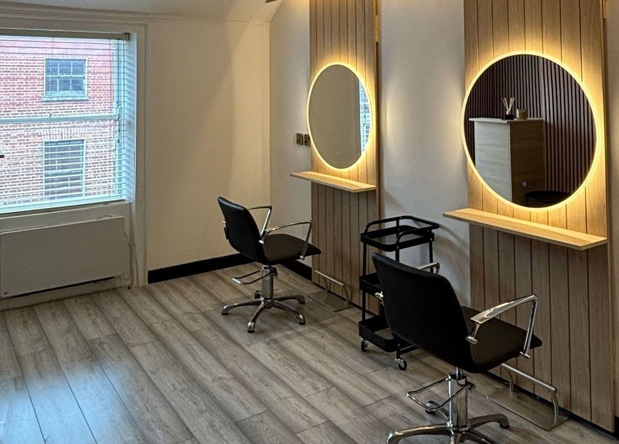 Modern salon interior at The Hair Room in Dublin, County Dublin, IE featuring chic styling stations.