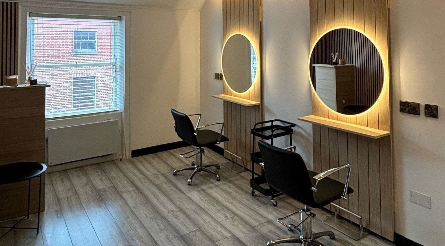 Modern salon interior at The Hair Room in Dublin, County Dublin, IE featuring chic styling stations.