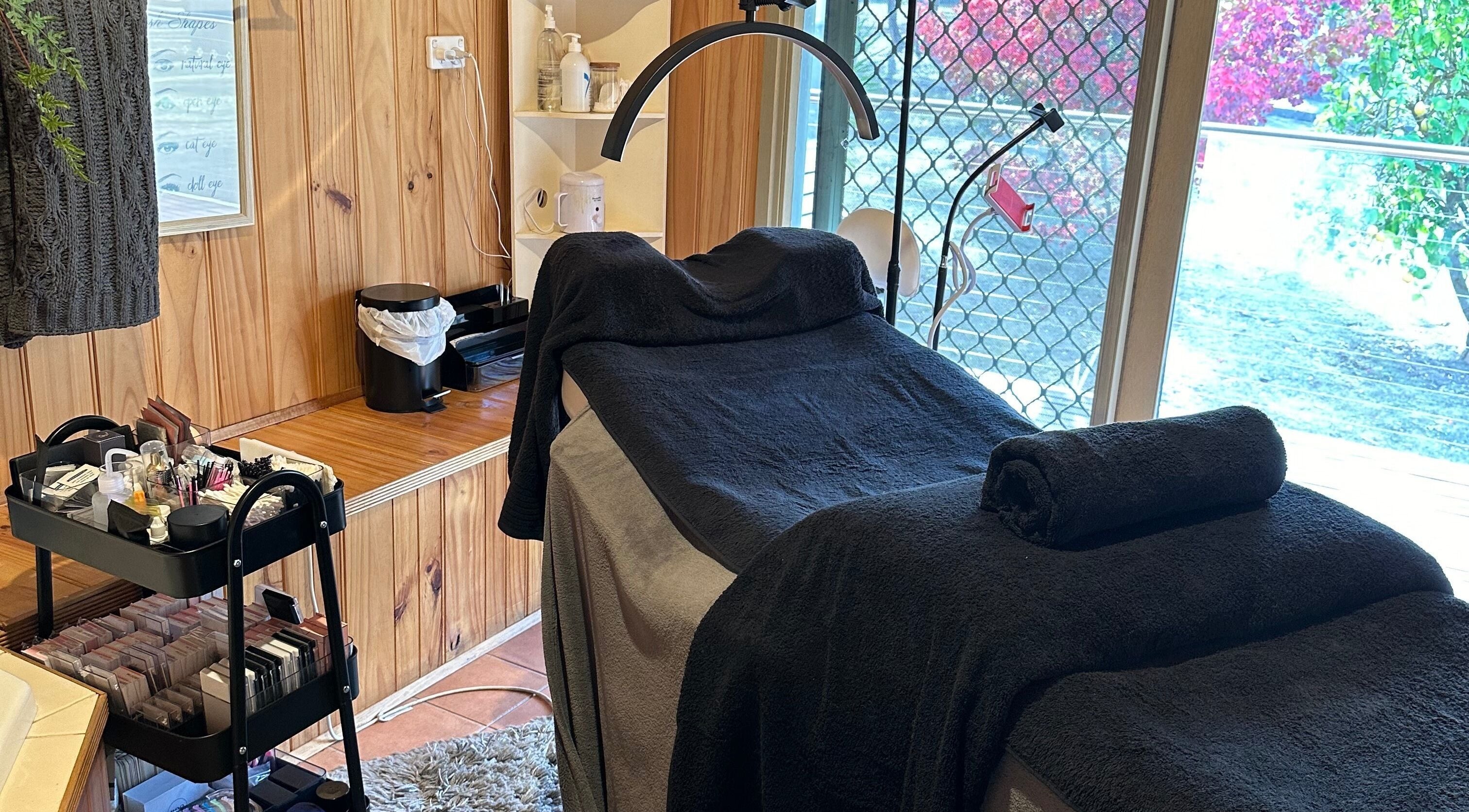 PLlashnbrow treatment room with a massage table and beauty products, Melbourne, Victoria, AU.