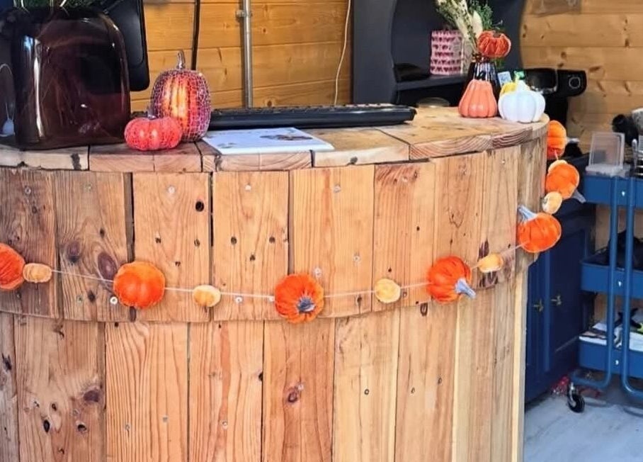 Rustic wooden reception at Aimez Vous, Marks Tey, England, GB, adorned with autumn decorations.