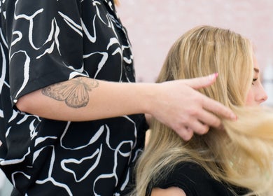 Professional hair stylist working at HairyAdelaide, Mona Vale, New South Wales, AU, enhancing blonde hair.