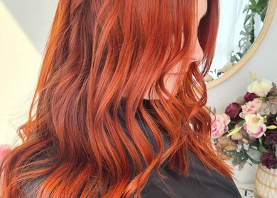 Woman with vibrant red hair styled in waves at HairbyMrsBlades, Porirua, Wellington Region, NZ.