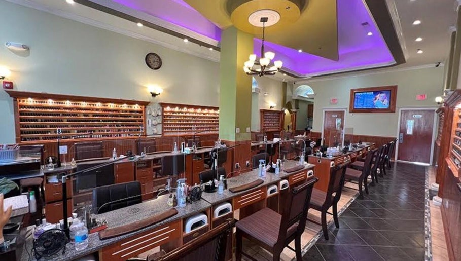 Inside Athena nail spa in Naperville, Illinois, US, featuring elegant nail stations and ambient lighting.