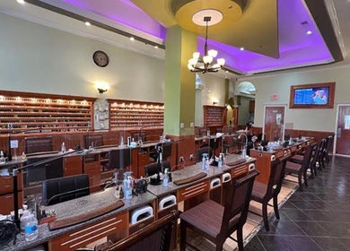 Inside Athena nail spa in Naperville, Illinois, US, featuring elegant nail stations and ambient lighting.