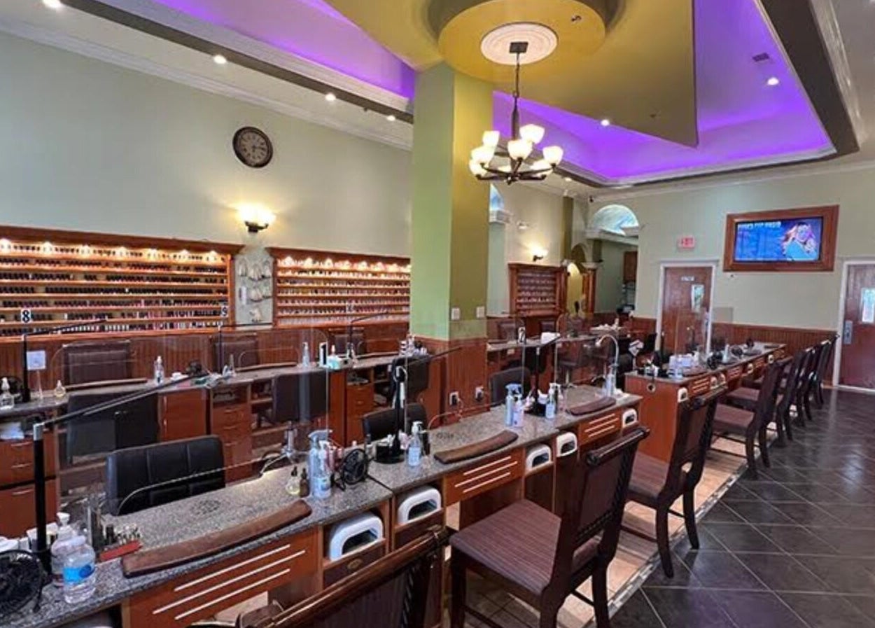 Inside Athena nail spa in Naperville, Illinois, US, featuring elegant nail stations and ambient lighting.