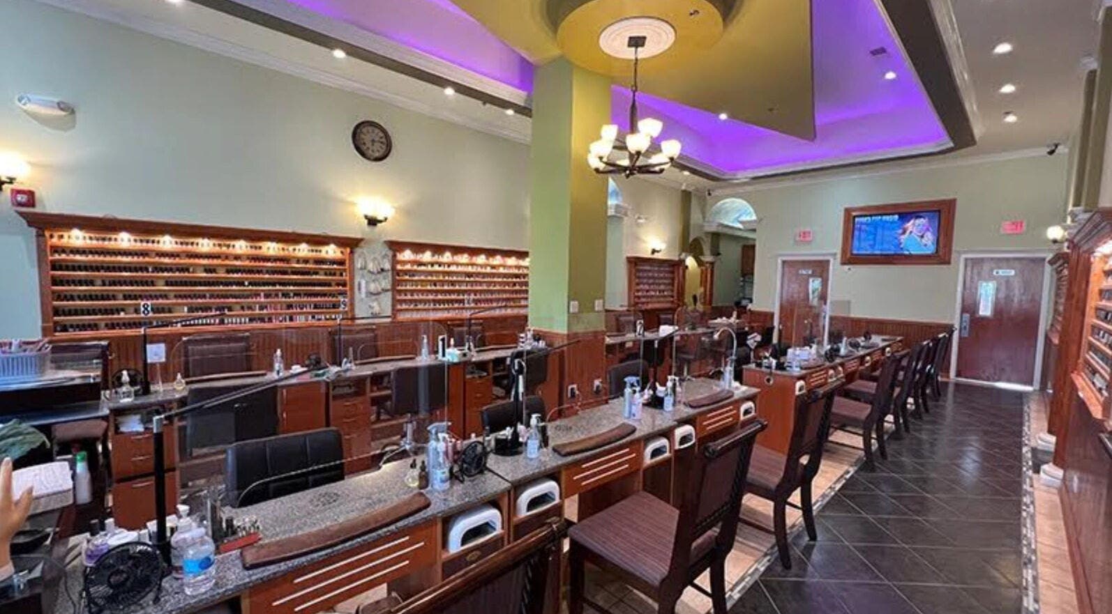 Inside Athena nail spa in Naperville, Illinois, US, featuring elegant nail stations and ambient lighting.