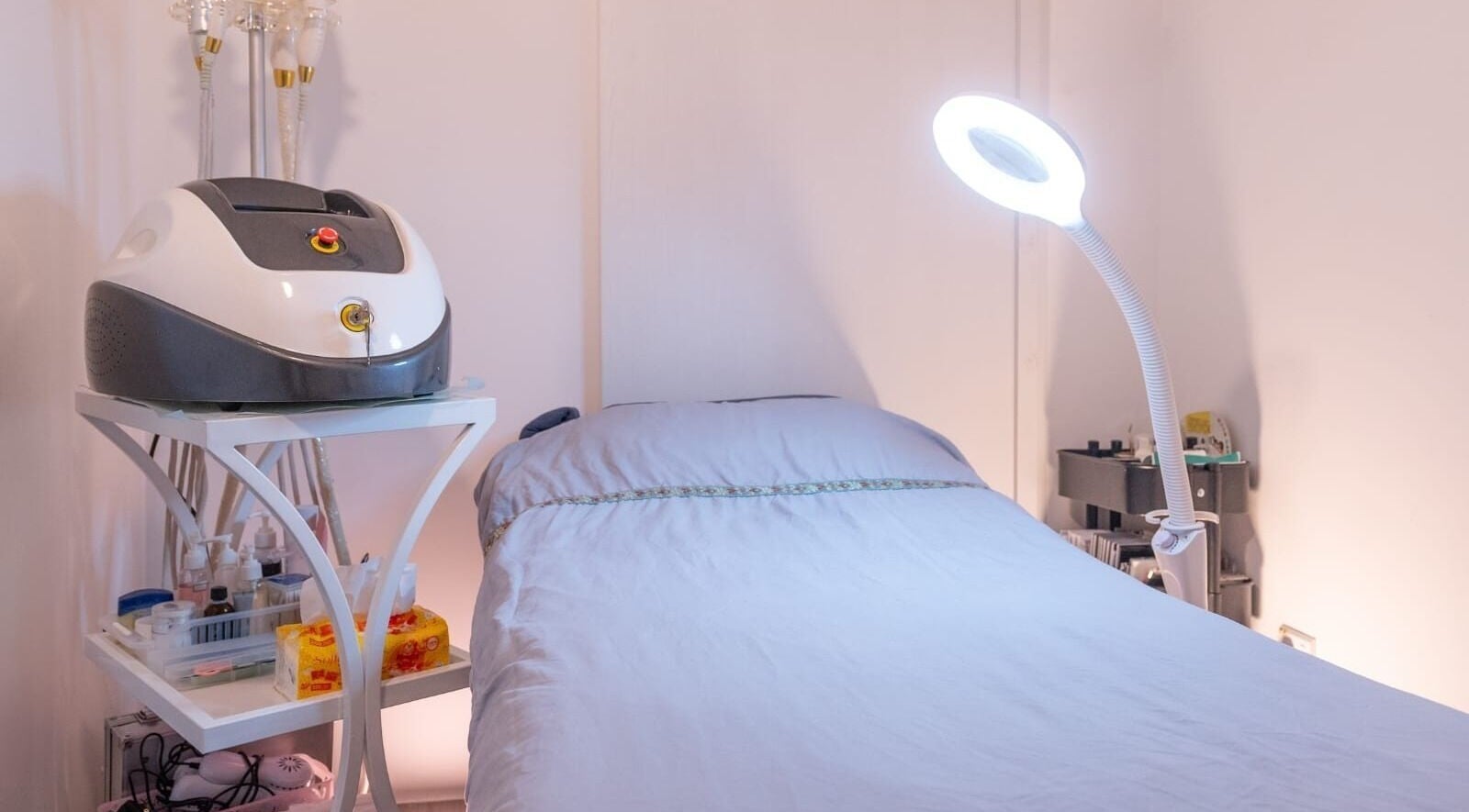 Treatment room at Skin K Solution Beauty in Singapore, SG, featuring a cozy bed and modern equipment.