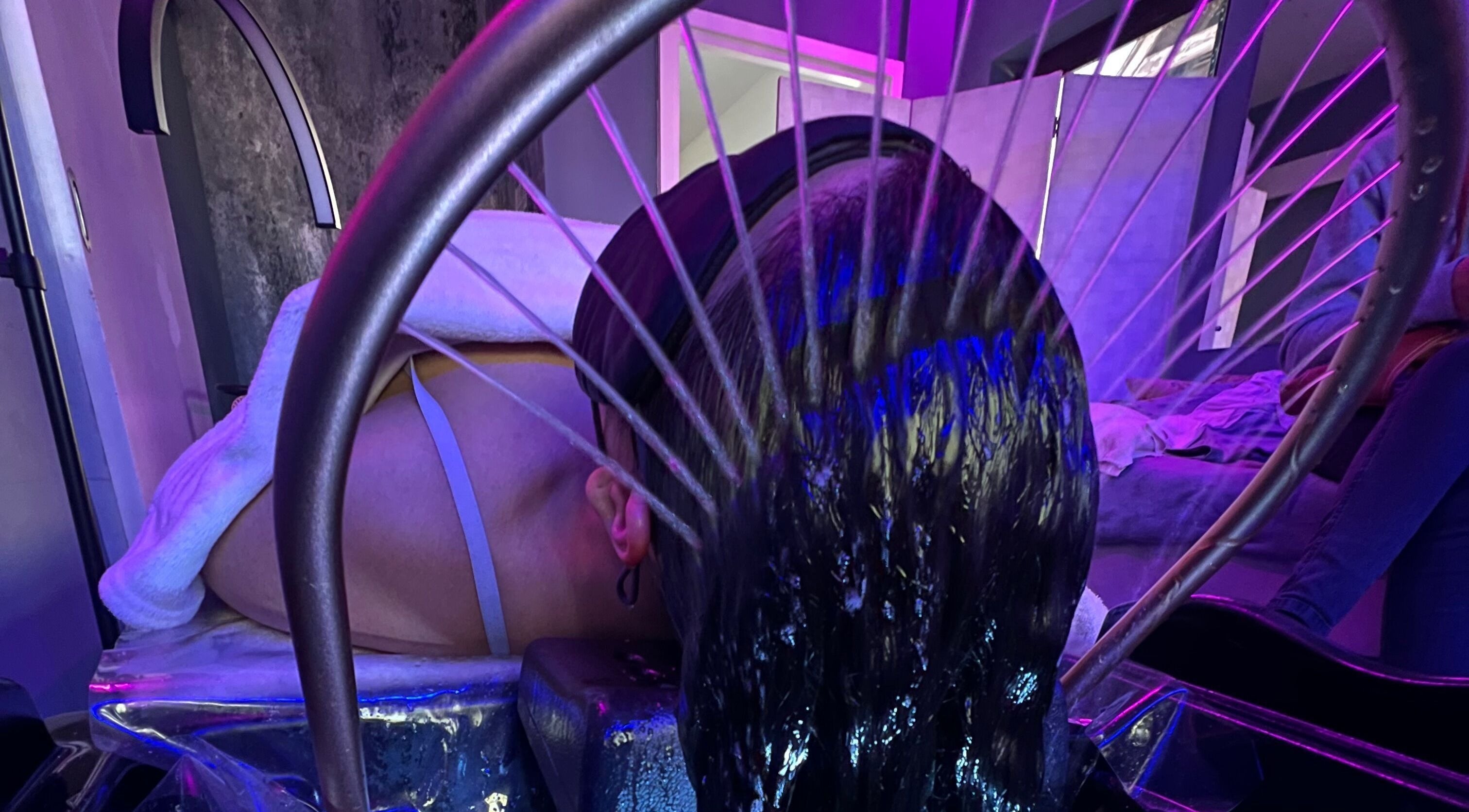 A relaxing hydrotherapy treatment at CC Euphoria, Cape Town, ZA with water gently cascading on a client's head.