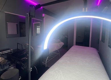 Relaxing spa room at CC Euphoria, Cape Town, ZA with a cozy massage bed under soft ambient lighting.