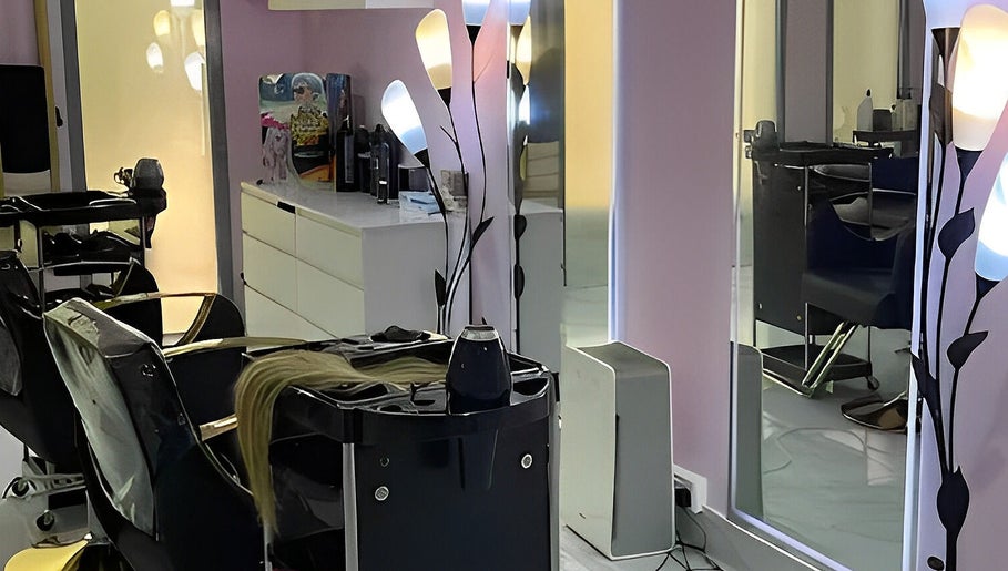 Modern salon interior at Hello Dolly Beauty Center, Doha, Doha Municipality, QA with sleek chairs and vibrant lighting.