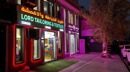 Exterior of Hello Dolly Beauty Center, glowing neon lights in Doha, Doha Municipality, QA.