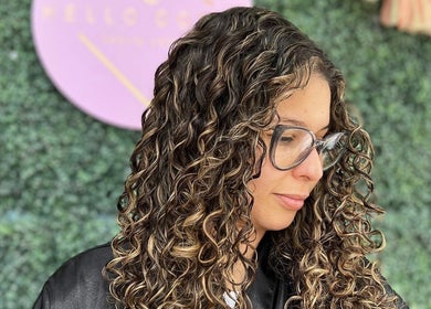 Close-up of a woman with curly hair at Hello Dolly Beauty Center in Doha, Doha Municipality, QA.