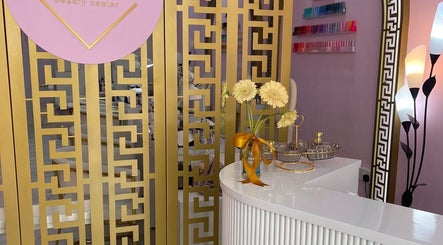 Welcome desk at Hello Dolly Beauty Center, Doha, adorned with flowers and intricate decor.