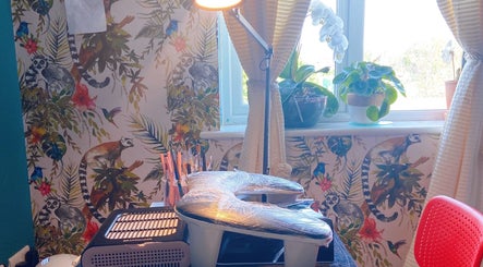 Cozy nail setup with vibrant jungle wallpaper at Nailxtation, Salford, England, GB.