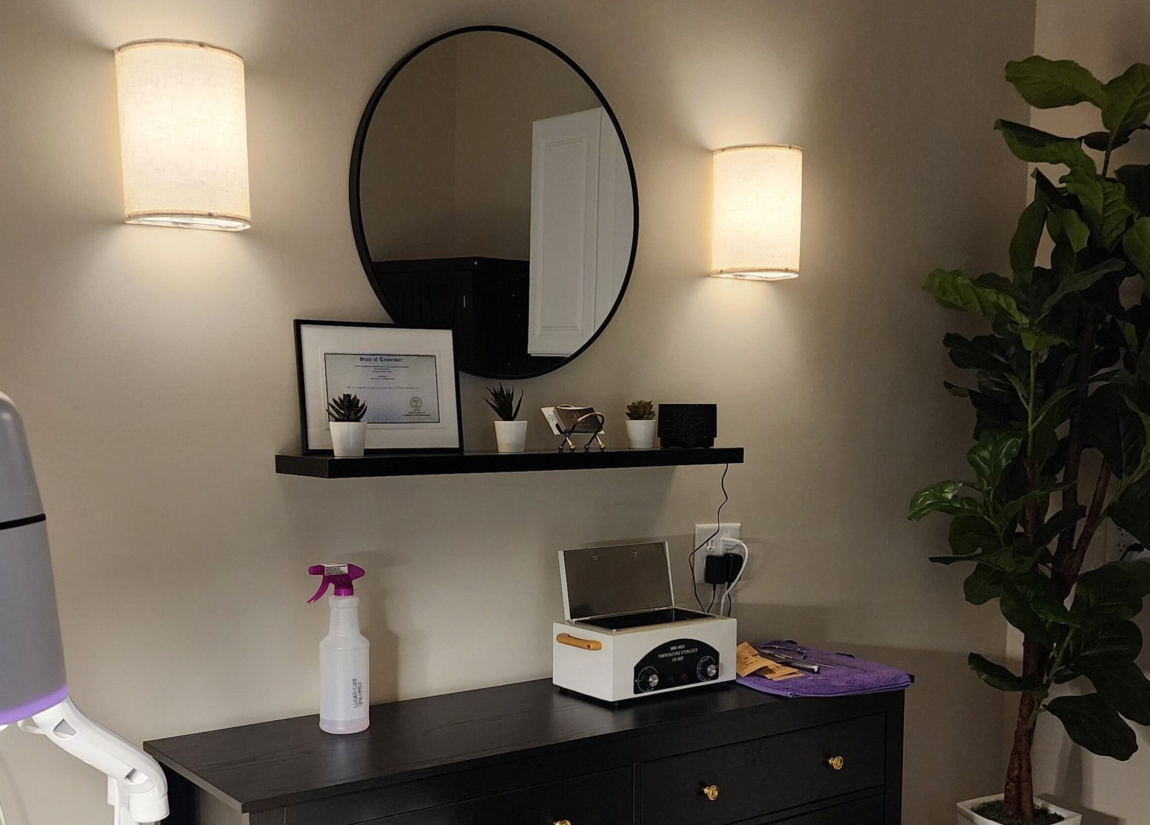 Elegant interior decor at Golden Kate Nails, Clarksville, Tennessee, featuring a mirror, plants, and soft lighting.