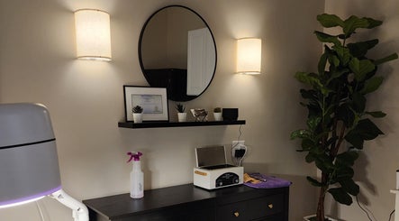 Elegant interior decor at Golden Kate Nails, Clarksville, Tennessee, featuring a mirror, plants, and soft lighting.