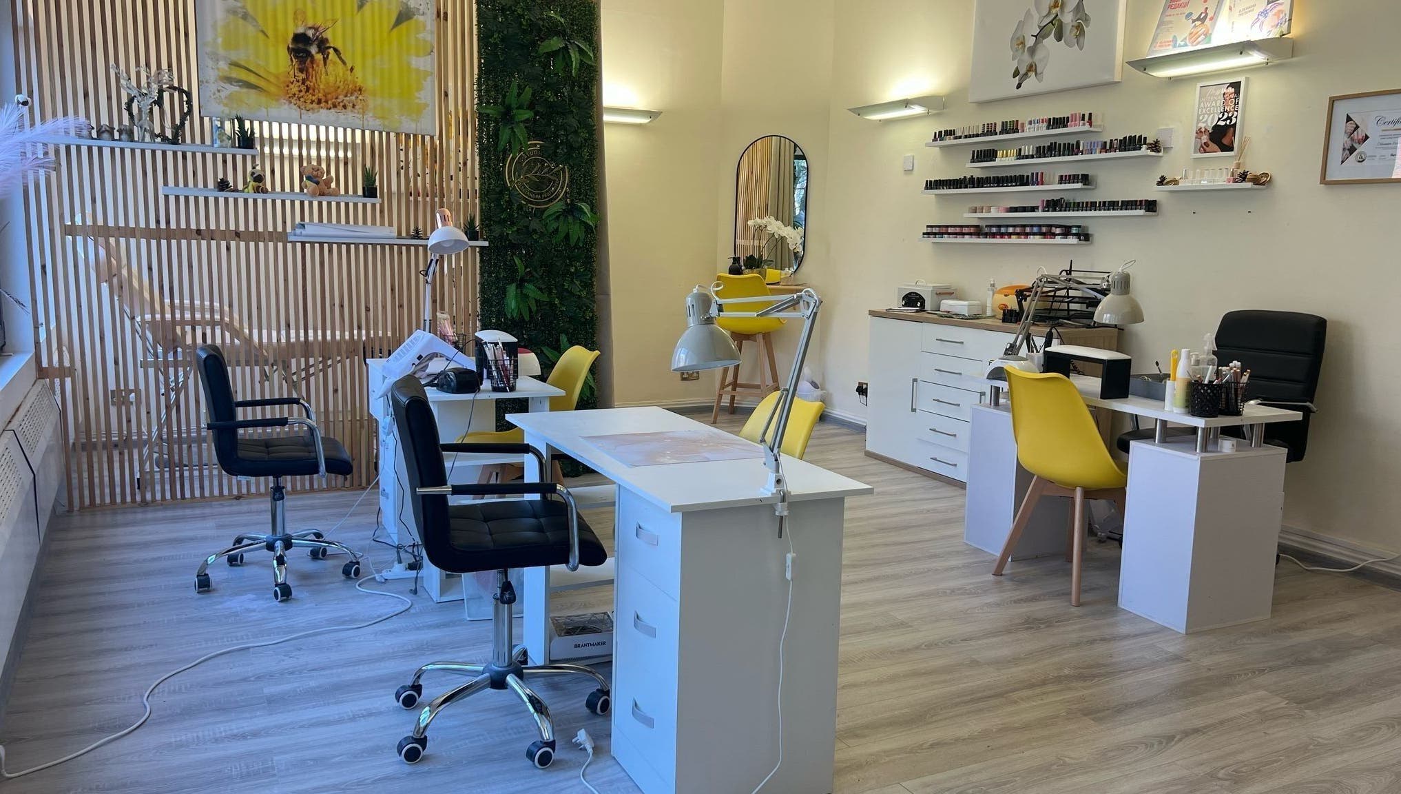 Modern beauty salon interior at Studio Oleksandra Protsenko, Nottingham, England, GB with chairs and nail polish display.