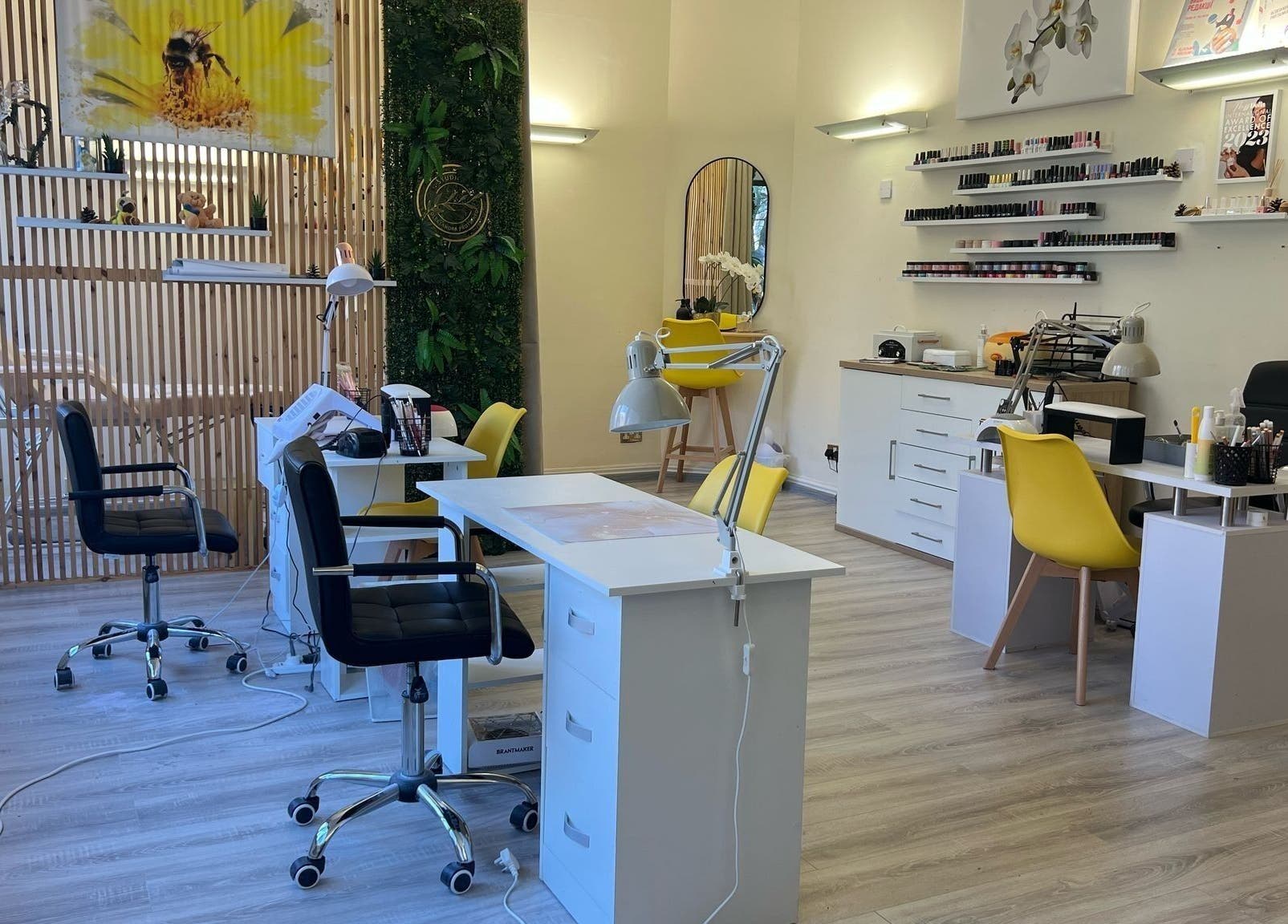Modern beauty salon interior at Studio Oleksandra Protsenko, Nottingham, England, GB with chairs and nail polish display.
