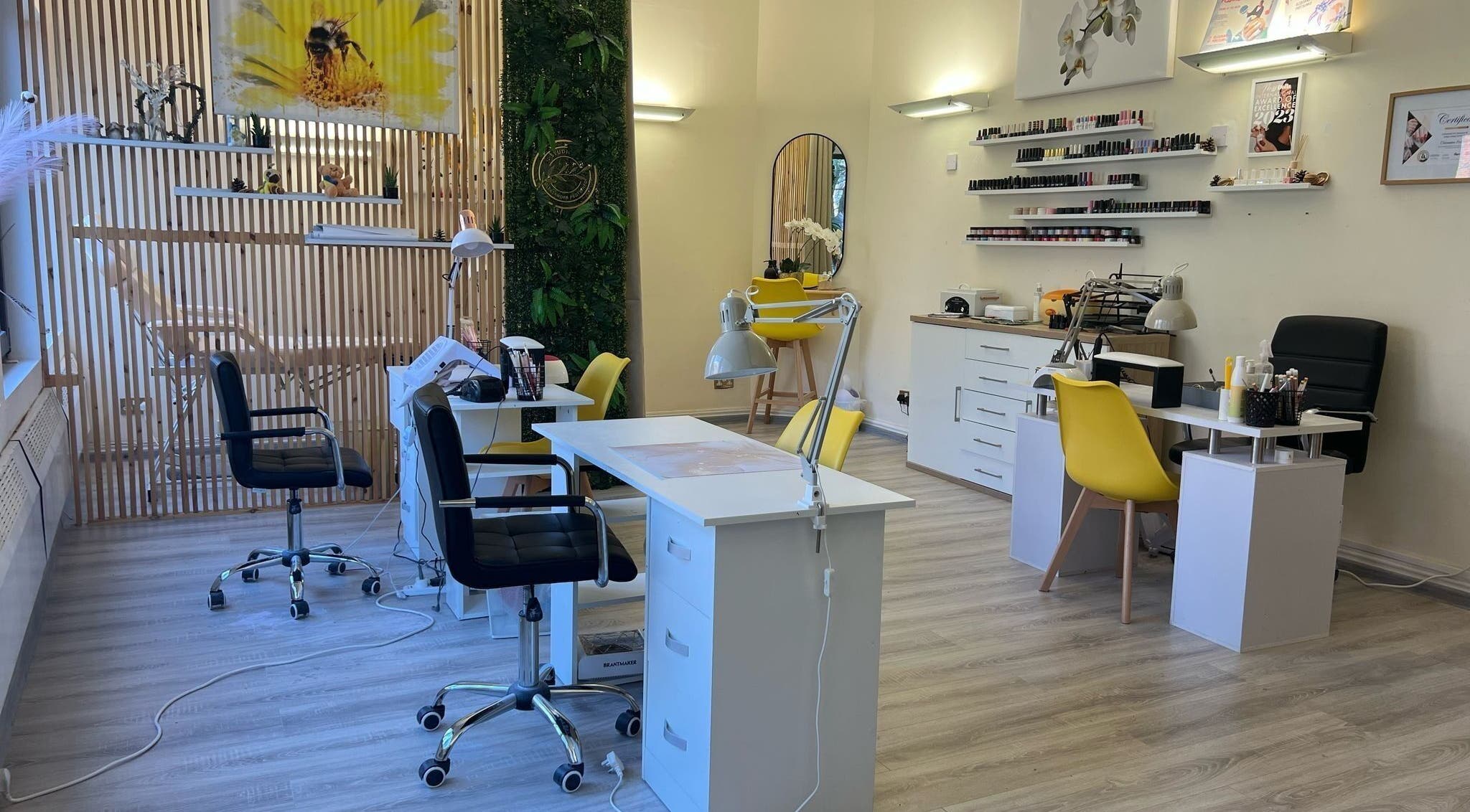 Modern beauty salon interior at Studio Oleksandra Protsenko, Nottingham, England, GB with chairs and nail polish display.