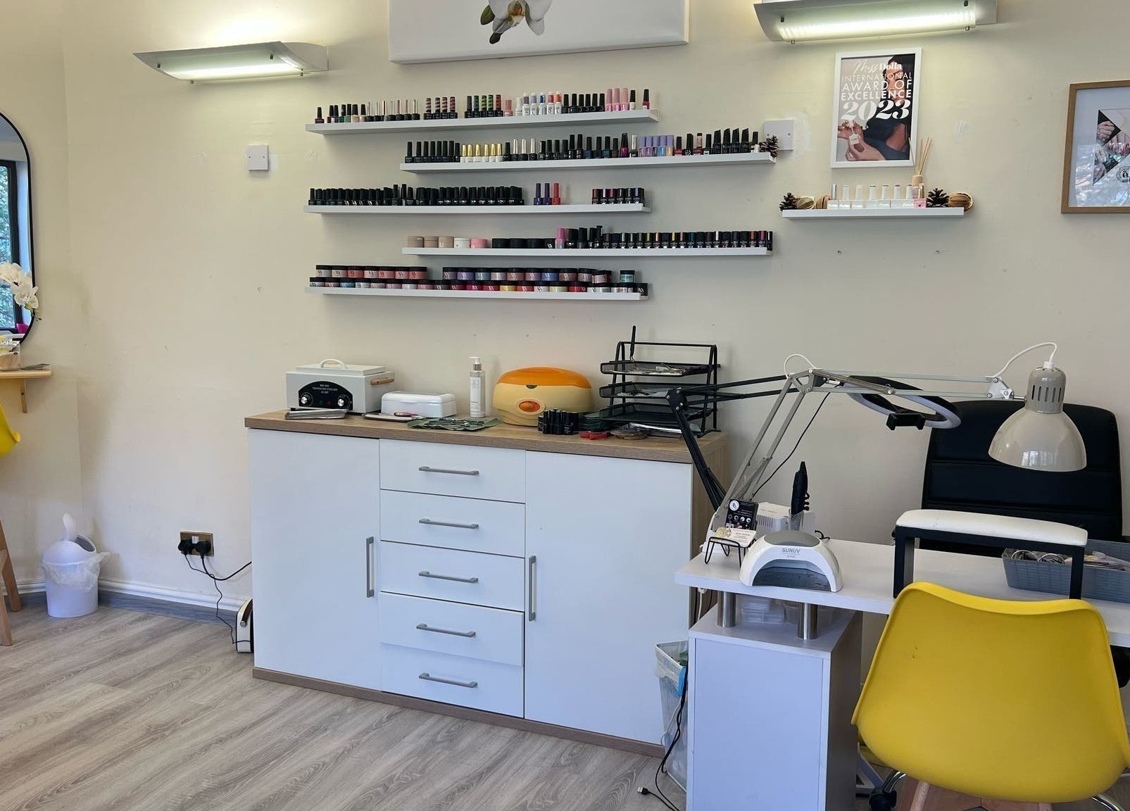 Studio Oleksandra Protsenko in Nottingham, England, GB, featuring a stylish nail bar with yellow seating and polish display.