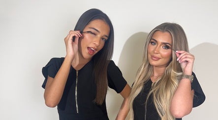 Two women applying makeup at XOXO Studios, West Wickham, England, GB.