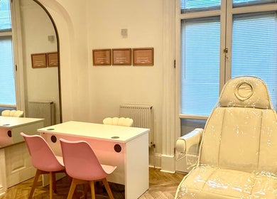 Elegant treatment room at Balanced Sculpt, Birmingham, England, GB featuring pink chairs and a plush recliner.