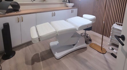 Luxurious treatment room at Aura Beauty, Aberdeen, Scotland, GB featuring a modern white spa bed.