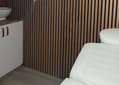 Modern treatment room at Aura Beauty, Aberdeen, Scotland, GB with white spa bed and sleek design.