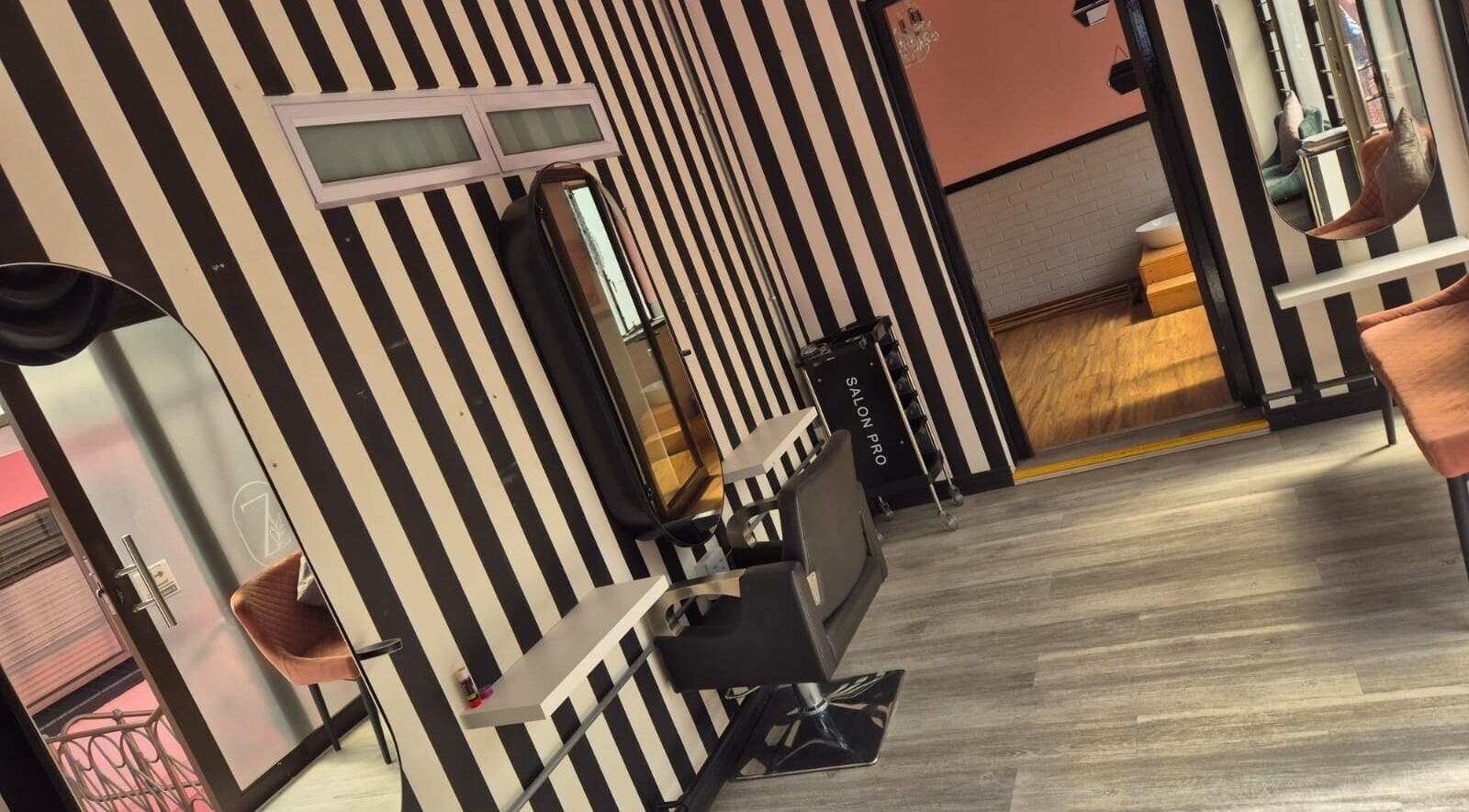 Modern salon interior at CheZel & Co, Springs, Gauteng, ZA with striped walls and stylish decor.