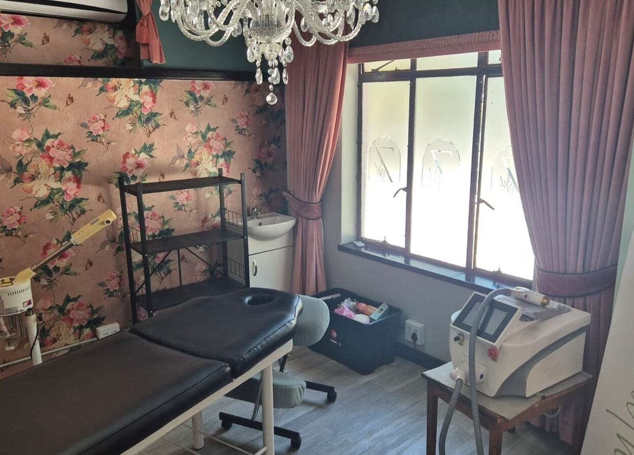 Elegant treatment room at CheZel & Co in Springs, Gauteng, ZA with floral wallpaper and crystal chandelier.