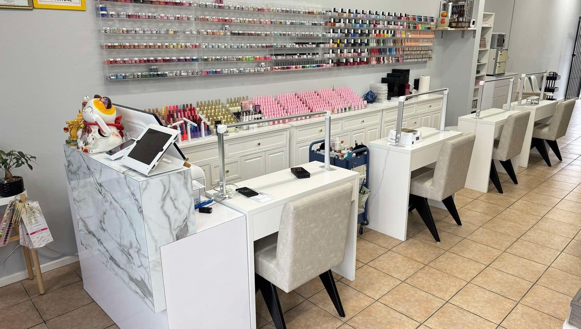 Manicure stations at Shiny Nails in Pasadena, California, US, showcasing vibrant nail polish displays.