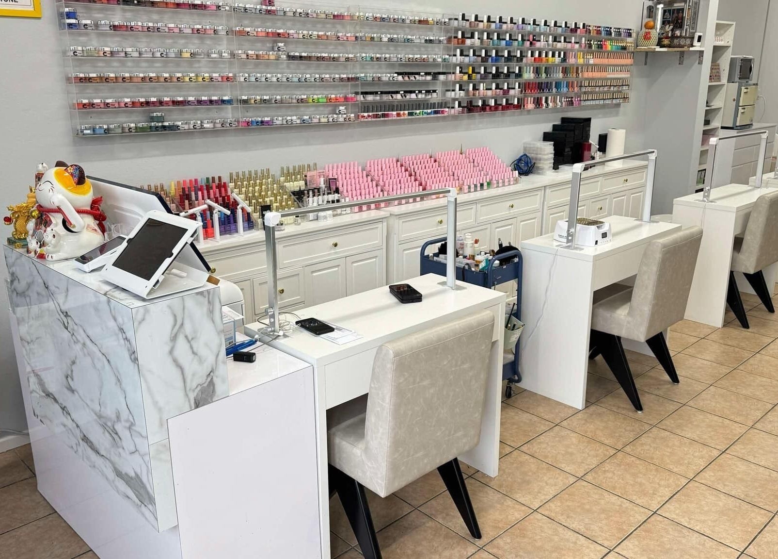 Manicure stations at Shiny Nails in Pasadena, California, US, showcasing vibrant nail polish displays.