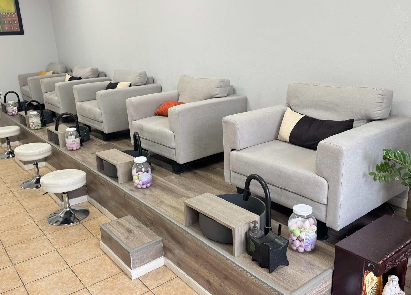 Luxurious pedicure stations at Shiny Nails in Pasadena, California, US, featuring plush seating and elegant decor.