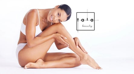 Smiling woman showcasing smooth skin at Tala Beauty Bar in Toronto, Ontario, CA.