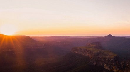 Breathtaking sunset view from South Coast Presence in Woodstock, New South Wales, AU over rolling hills.