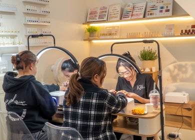 Visitors enjoying nail services at Kim Studio, Thành Phố Đà Lạt, Lâm Đồng, VN. Relaxing beauty experience.