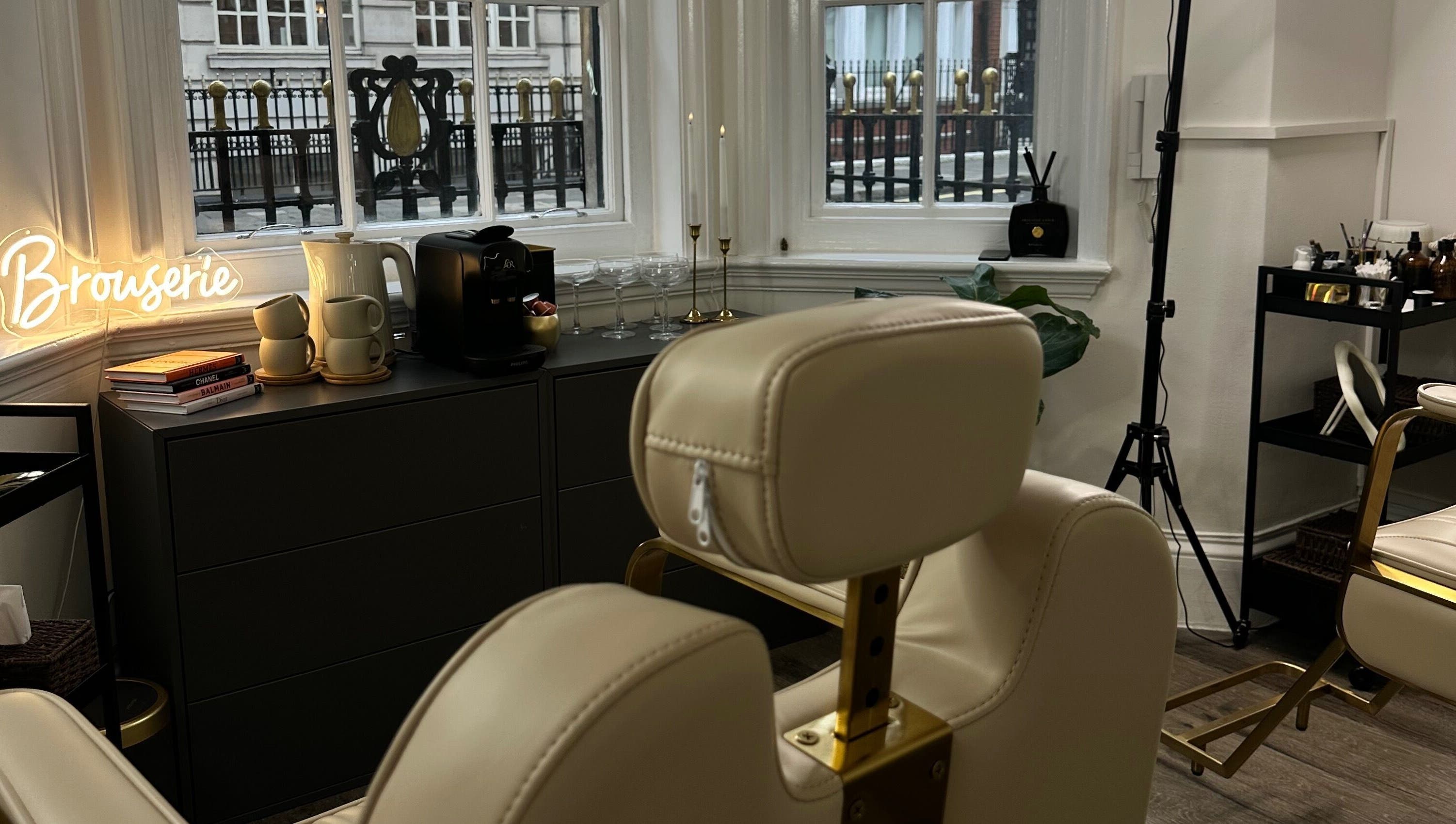 Elegant interior of Browserie London with cream chairs and decor in London, England, GB.