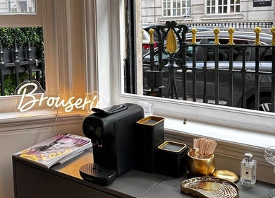 Elegant cafe setup at Browserie London, showcasing coffee amenities with street view in London, England, GB.